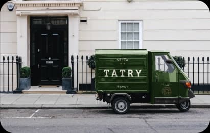 green van with hotel advertisement and QR code for ordering rooms