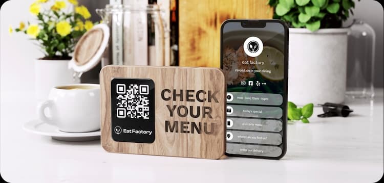 table wooden advertisement with QR code which after scanning opens the ordering page for eat factory restaurant